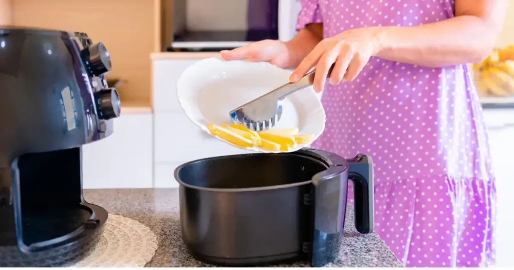 a women putting leftover food in air fryer