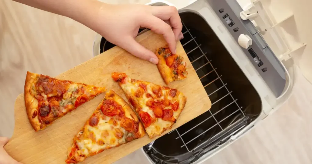 putting leftover pizza in air fryer basket