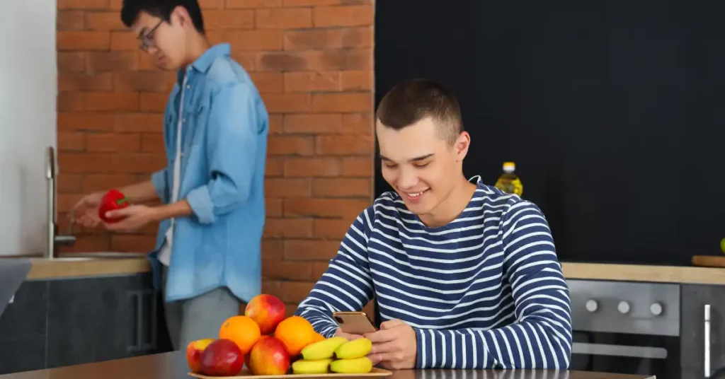 two friends in dormitory's kitchen